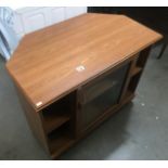 A teak effect glazed corner TV stand.