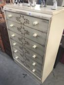 A shabby chic cream coloured 6 drawer chest with brown vine stencilling.