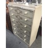 A shabby chic cream coloured 6 drawer chest with brown vine stencilling.