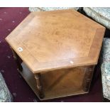 A hexangonal medium oak stained coffee table.