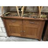 A wooden 2 drawer 2 door cabinet.