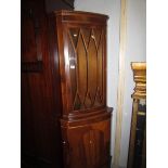 A mahogany corner cabinet.