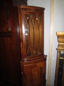 A mahogany corner cabinet.