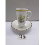 A Royal Worcester floral decorated tea cup and saucer.