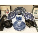 A quantity of blue and white and back pottery including platters and tea pots.