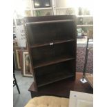 A 1930s dark oak bookcase.