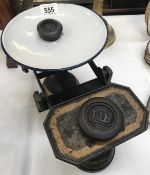 A set of scales marked W S Barrett & Son Boston with 2 weights.