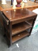 An Edwardian mahogany tea trolley.