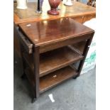 An Edwardian mahogany tea trolley.