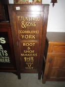 An old cupboard with stencilled lettering to doors.