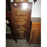 An old cupboard with stencilled lettering to doors.