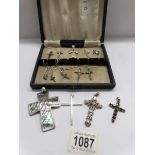15 assorted silver cross pendants.