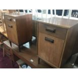 A pair of teak bedside cabinets.