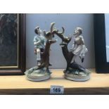 A pair of pottery figures of children climbing trees.