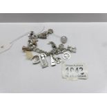 A silver charm bracelet with silver padlock and 13 charms.