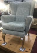 A Parker Knoll style armchair on queen anne legs.