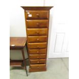 A tall 9 drawer chest.