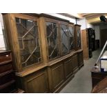 A large glazed break front display cabinet & matching corner cabinet