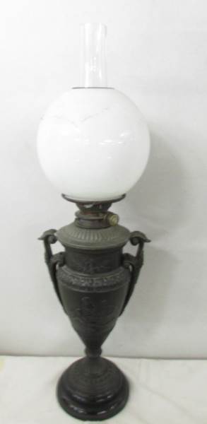 A Victorian Hink's spelter oil lamp in the form of an urn with drop in font and complete with shade