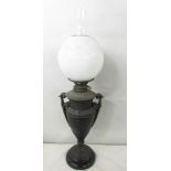 A Victorian Hink's spelter oil lamp in the form of an urn with drop in font and complete with shade