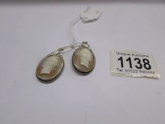 A pair of Cameo earrings.