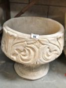 A fleur de lis urn depicting stylised 3 petal design.