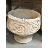 A fleur de lis urn depicting stylised 3 petal design.