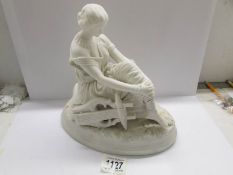 A Parian figure of a seated lady.