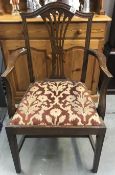 A carver chair with wheat sheaf back and flower upholstered seat.