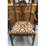 A carver chair with wheat sheaf back and flower upholstered seat.