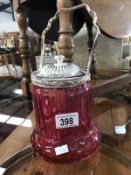 A cranberry glass biscuit barrell with silver plated fittings.
