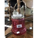 A cranberry glass biscuit barrell with silver plated fittings.