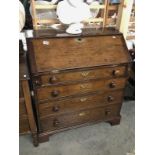 A 4 drawer oak bureau.