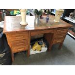 A 1950s double pedestal desk with leather insert.