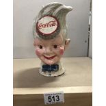 A cast iron Coca Cola head money box.