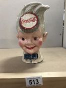 A cast iron Coca Cola head money box.