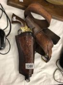 A replica navy colt with leather holster and case.