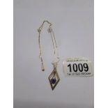 A 9ct gold pendant set blue stone and on chain.