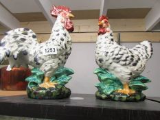A pottery hen and a pottery cockerel.