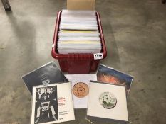 A box of mainly rock 45 rpm records.