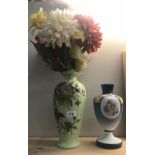 A hand painted vase and a hand decorated glass vase with cherubs.