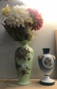 A hand painted vase and a hand decorated glass vase with cherubs.