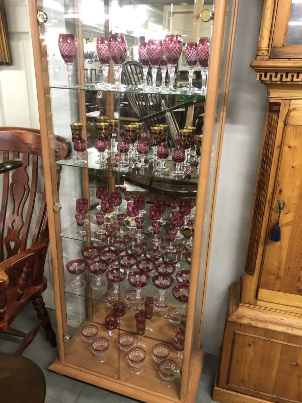 A large collection of assorted cranberry glass ware including gilded.