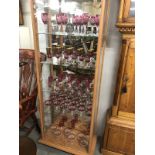 A large collection of assorted cranberry glass ware including gilded.