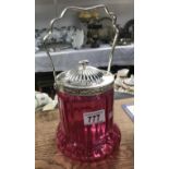 A cranberry glass biscuit barrel with silver plated fittings.