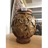 A carved wood vase.