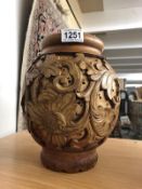 A carved wood vase.