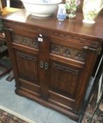 A linen-fold carved side cupboard.