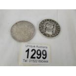 A 1780 Maria Theresa Thaler and a 1741 New Spain/Mexico 8 Reales coin.