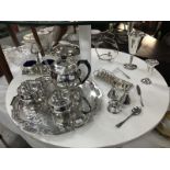 A collection of silver plate including tea set, goblets, condiment items etc.